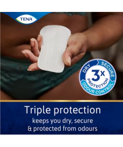 A close-up photo of a woman's hand holding a TENA Lights incontinence pad. The pad is white and rectangular, . The woman's hand is manicured and has short, painted nails. There is text at bottom in blue background which says 